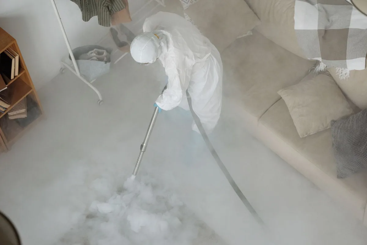 Biohazard cleanup technician in protective equipment, Goodrich, MI